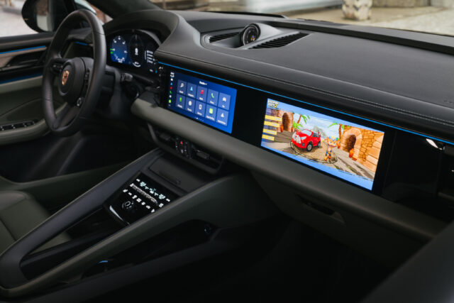 A Porsche Macan dashboard showing the passenger infotainment screen.