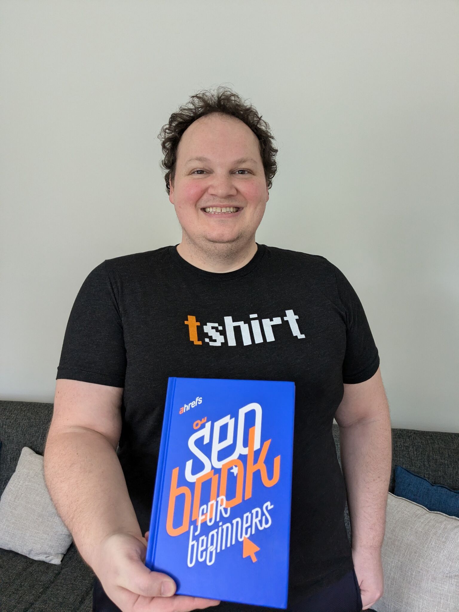 Patrick holding Ahrefs SEO book for beginners