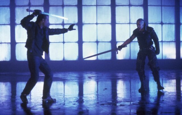 two swordsmen in silhouette in an industrial warehouse